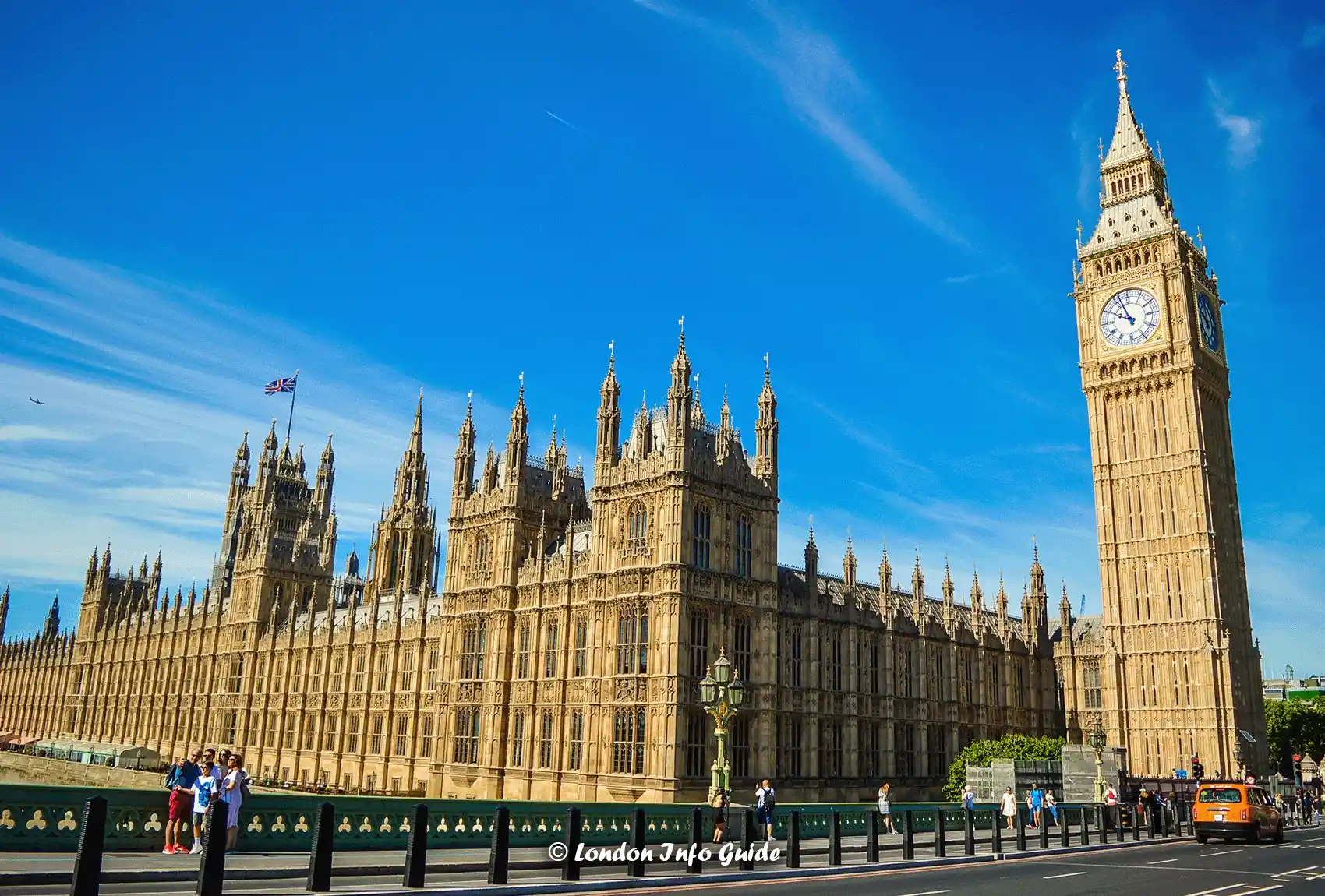 A family posing in front of the iconic Big Ben in London and Houses of Parliament for a selfie. A close-up view of the majestic Big Ben and Houses of Parliament.