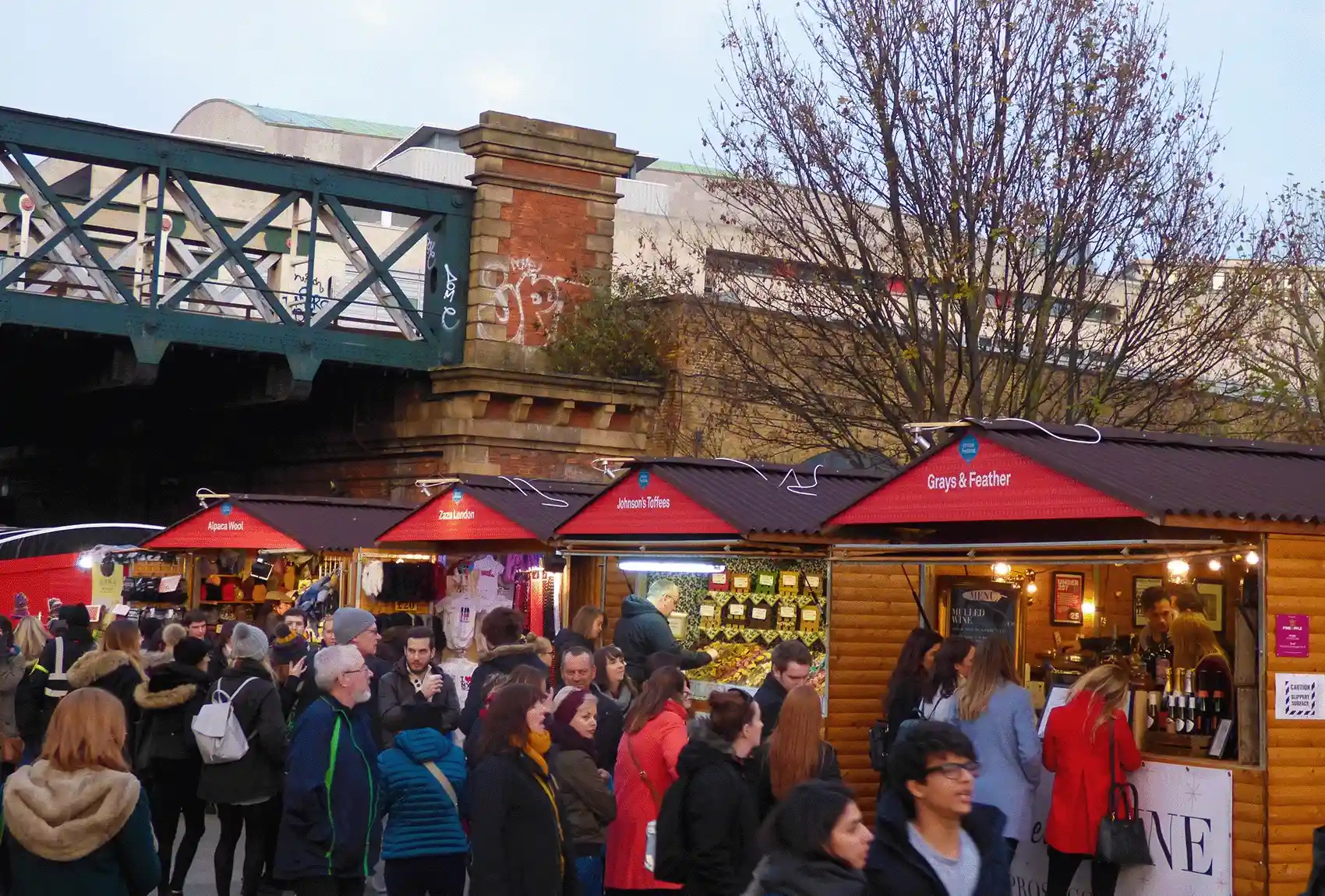 Discover London's SouthbankΒ lively Christmas market, which is located under a picturesque railway bridge and is home to festive vendors and holiday visitors. Shop festively at the Southbank, under the bridge, at the London Christmas Market.