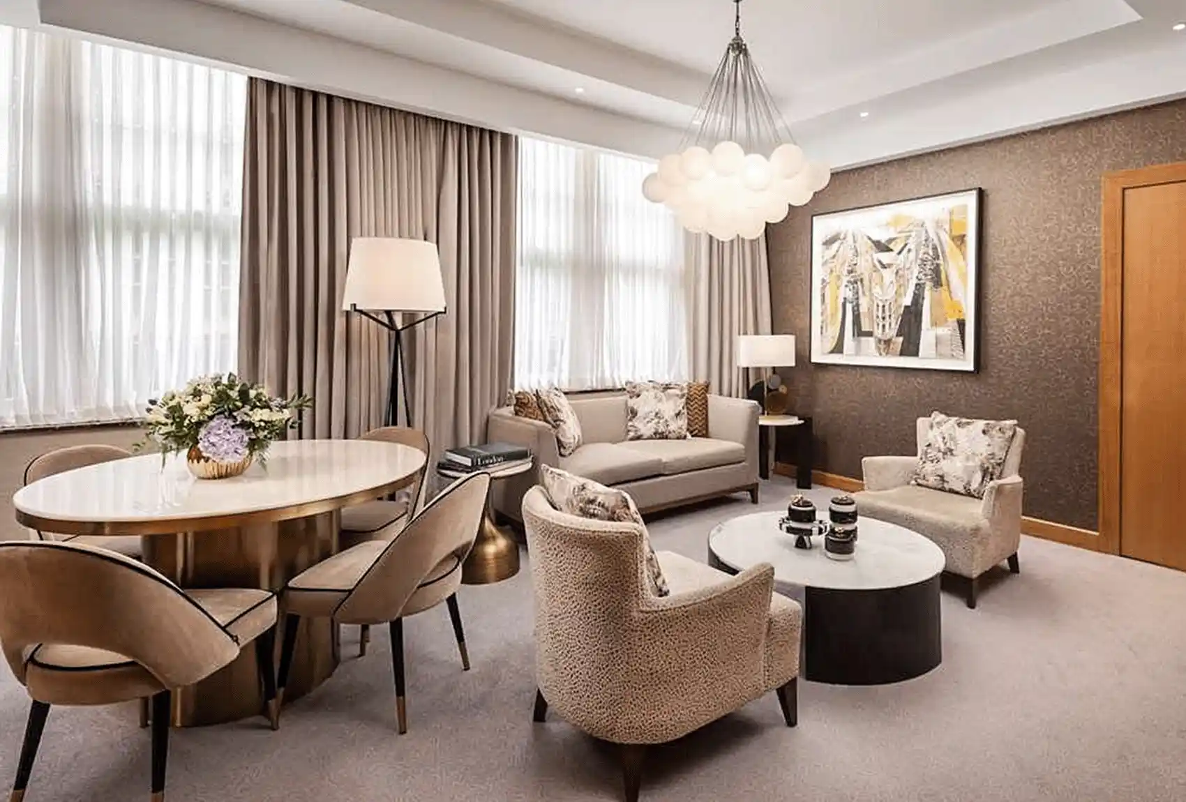 The Hotel Room With Dining Table And Sofas At The Conrad St. James Hotel london.