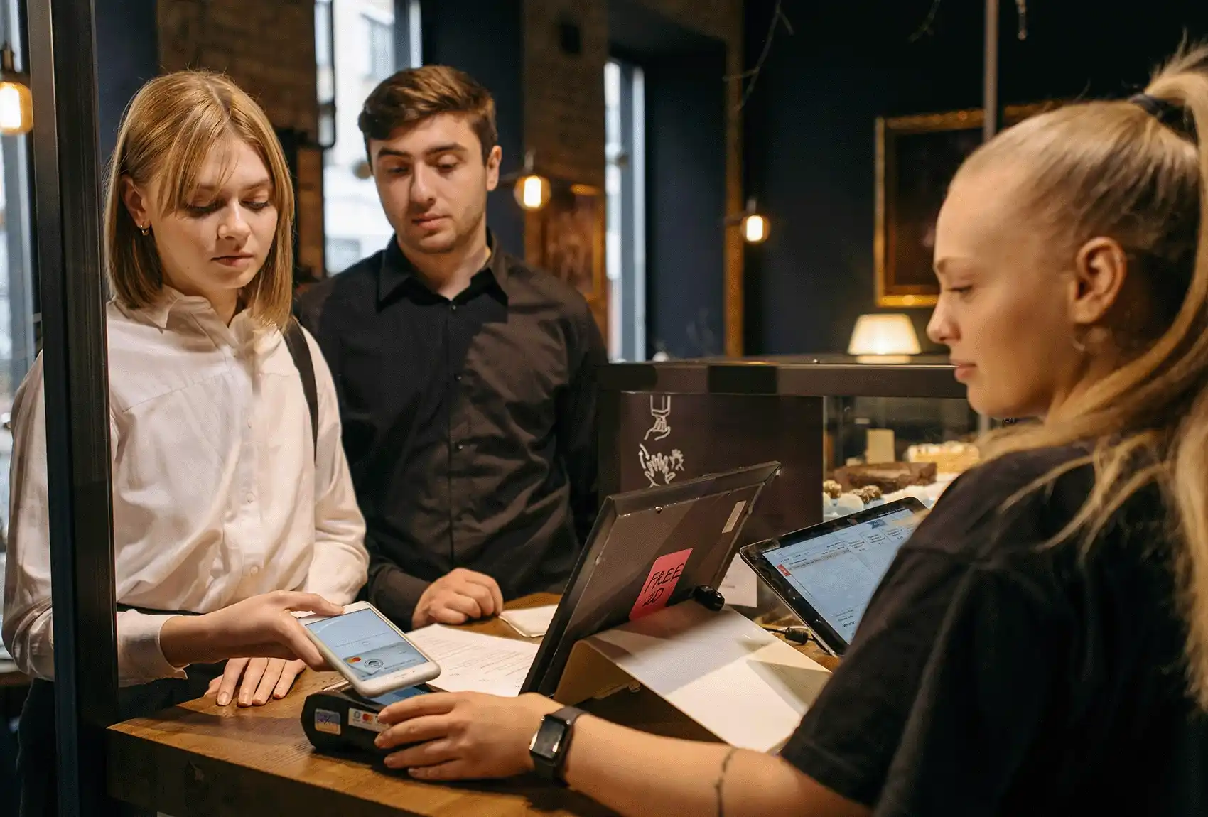 Clients at a commercial store paying with contactless payments.