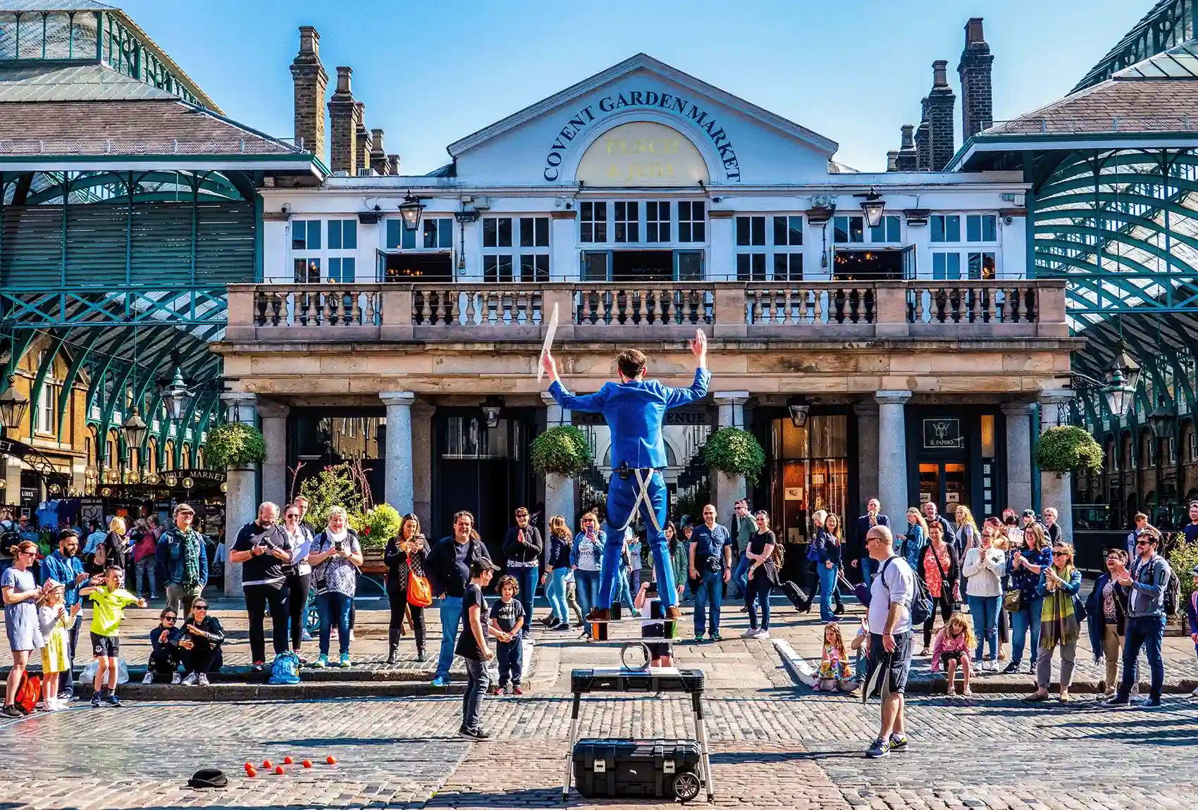 Street performer entertaining a crowd at Covent Garden in London.