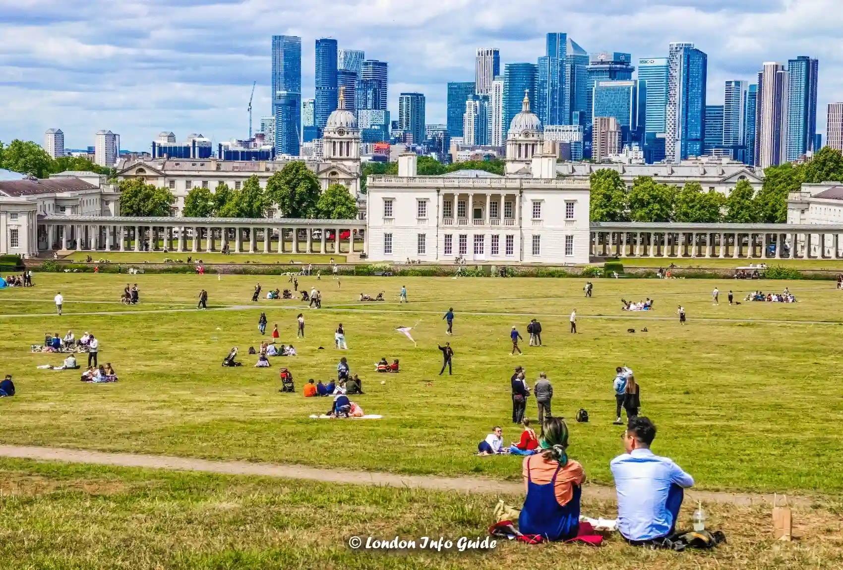 A view of the Queen's House and Canary Wharf skyline from the lawns of Greenwich Park Greenwich Park view of Queenβs House and Canary Wharf