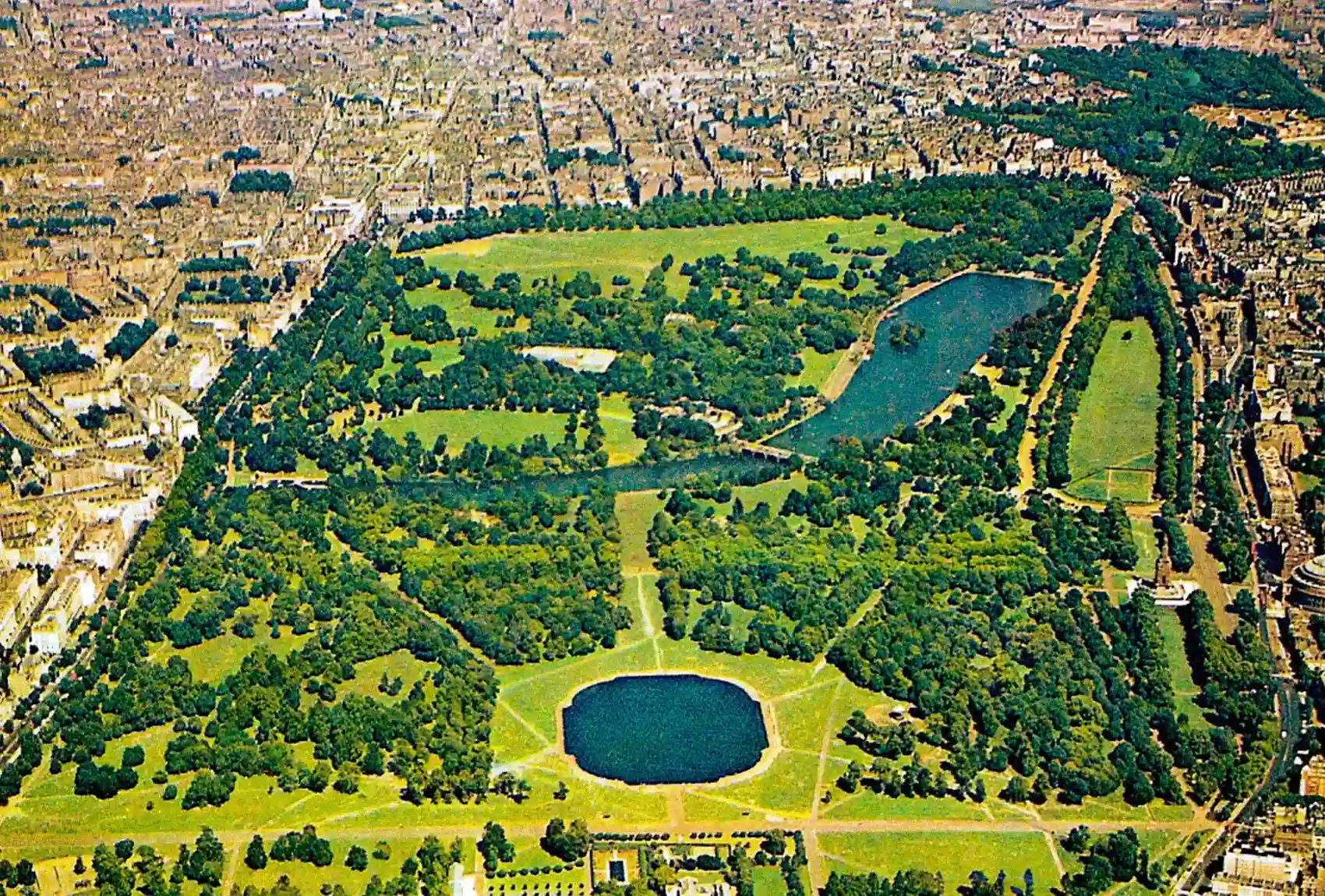 This aerial view of Hyde Park in London shows the Serpentine Lake and lush greenery Aerial view of Hyde Park, London, with lakes