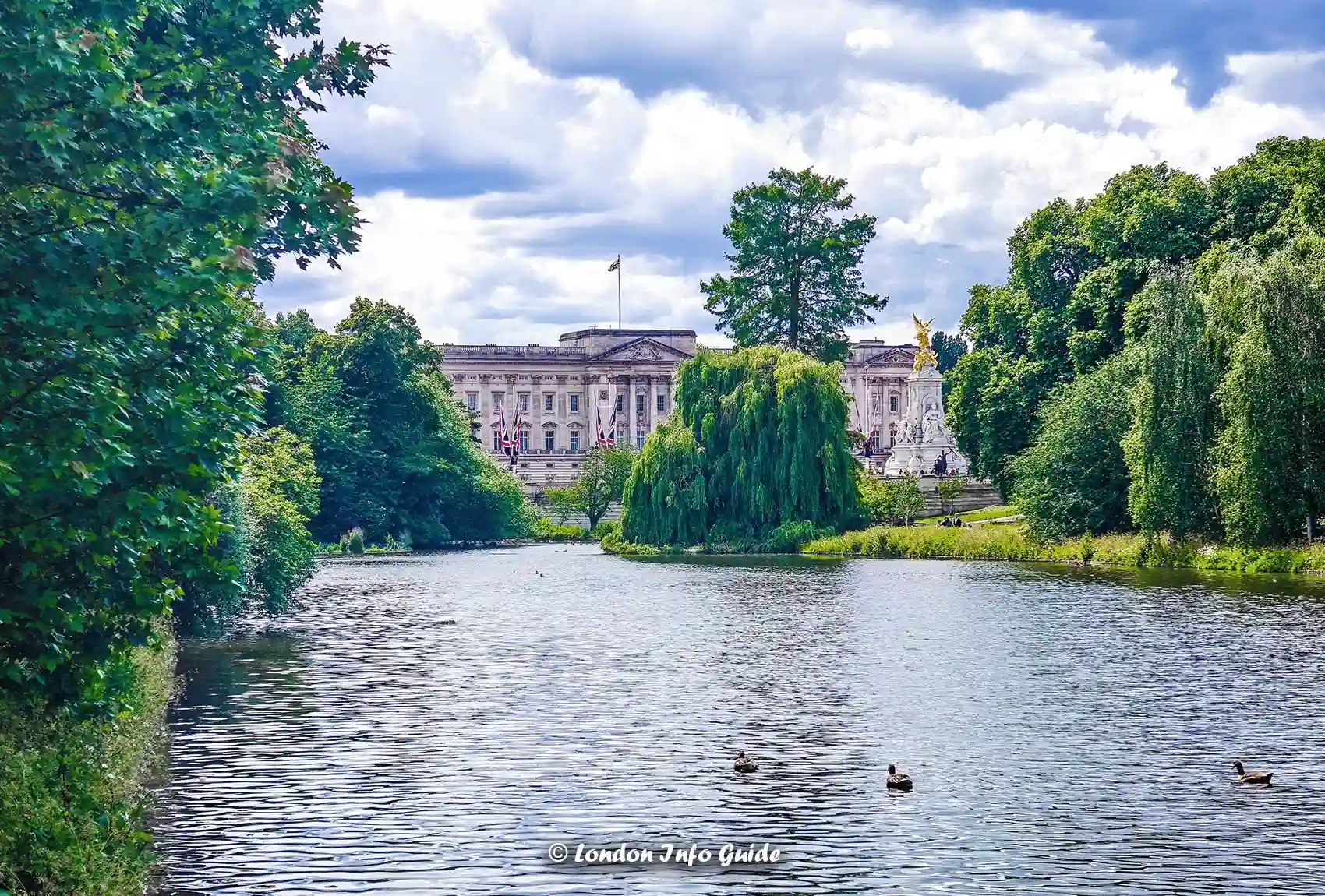 A scenic view across the lake at St James's Park towards Buckingham Palace and the Victoria Memorial St James's Park lake with Buckingham Palace in the background