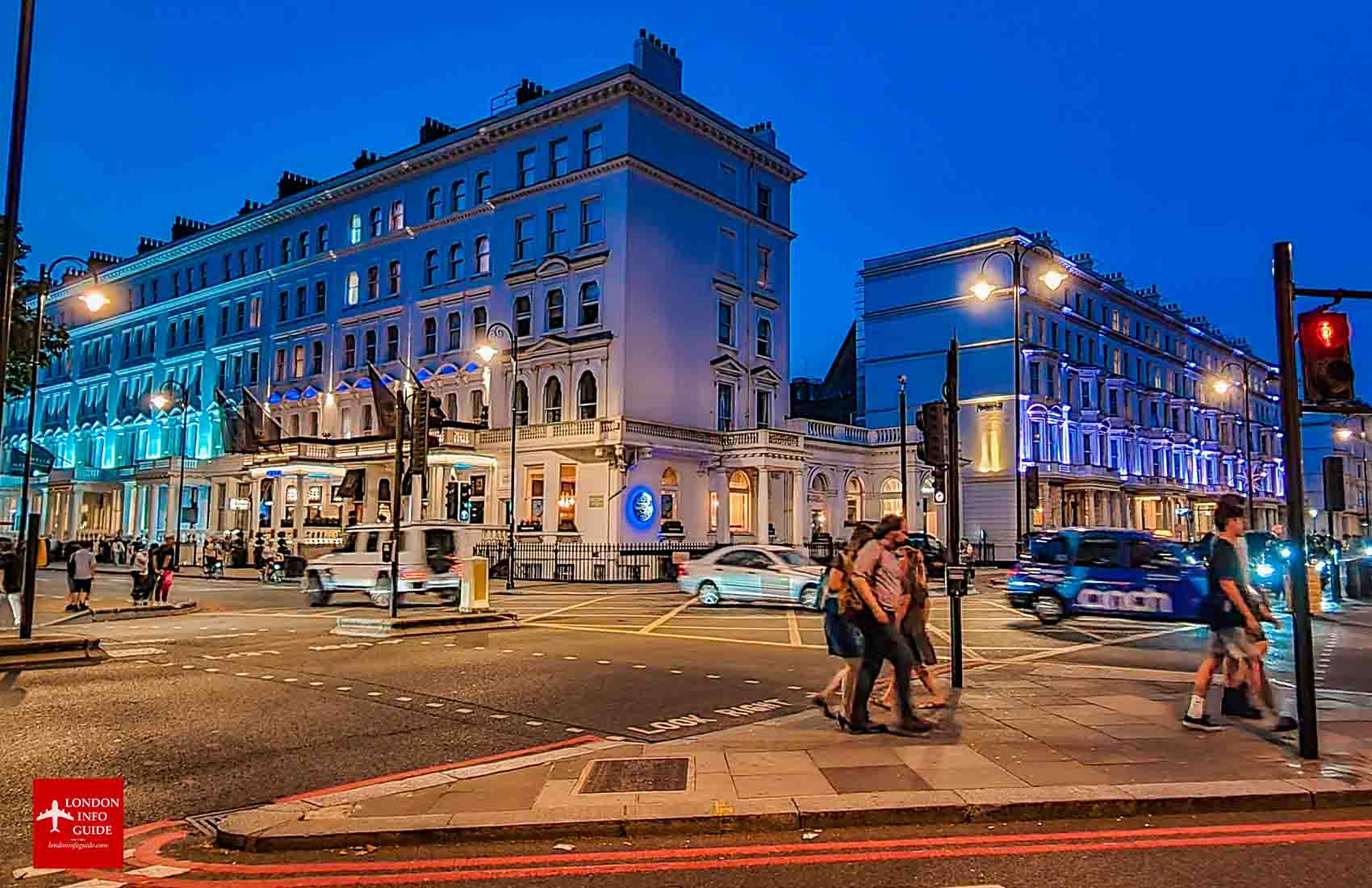 People and traffic passing through the Kensington borough in London. Kensington Borough in London England.