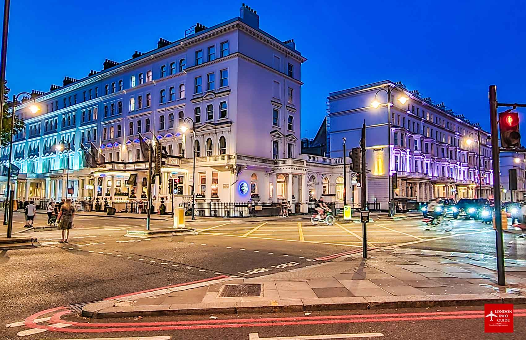 Street view of London at night with vibrant lights and historic buildings at Kensington Borough London. Night photography in a busy street in Kensington Borough.