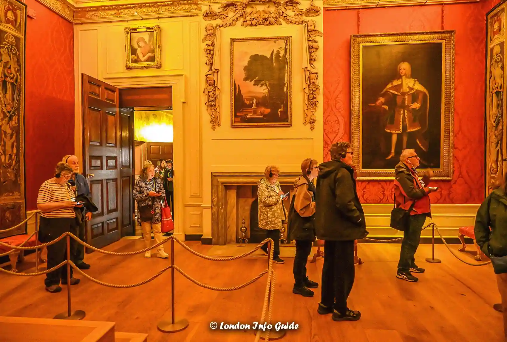Tourists exploring historic art inside Kensington Palace state room.