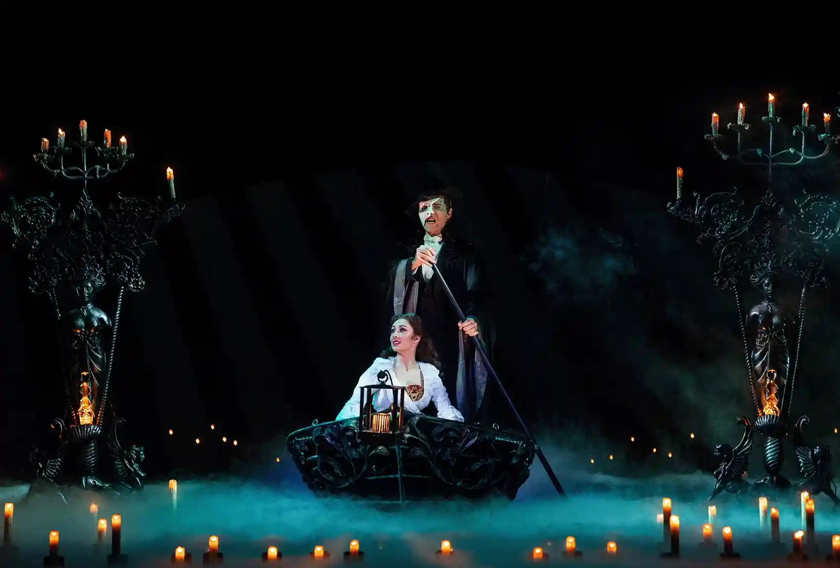 Scene from 'Phantom of the Opera Musical' with main characters on a boat.