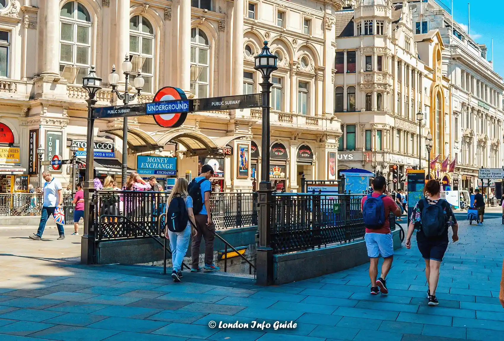 People walking around the heart of Mayfair in London with high-end shops and luxury cars. Navigate London's Underground Tube for easy travel.