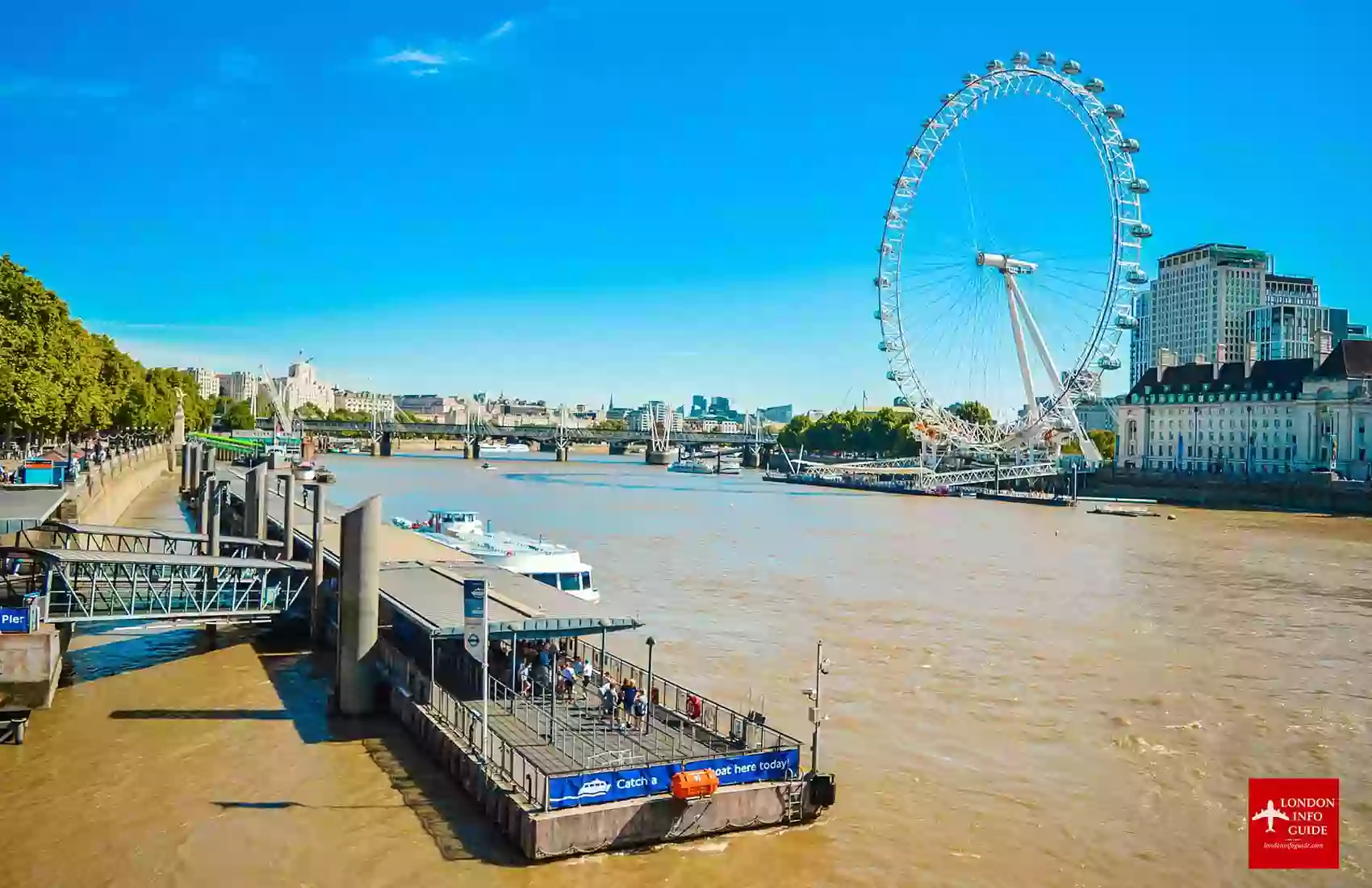 The beautiful view of the London Eye from the Westminster Bridge overlooking the River Thames. The view of London Eye from the Westminster Bridge overlooking the River Thames. Absolutely beautiful weather in London.