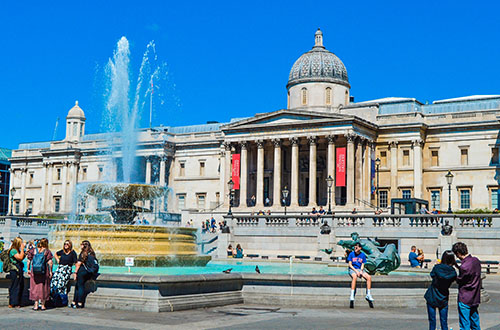 A sunny day at Trafalgar Square with the National Gallery in the background. National Gallery London.