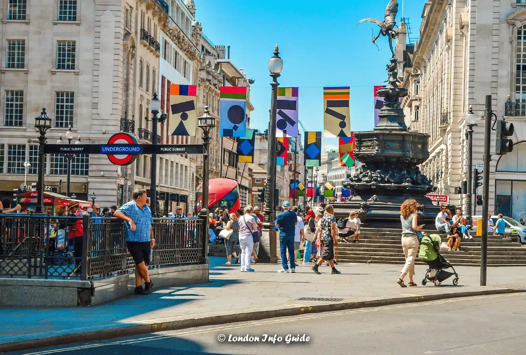 Piccadilly Circus, a bustling hub in central London, is always alive with crowds, vibrant banners, and the famous London Underground sign. Crowded Piccadilly Circus with London Underground sign and vibrant banners.
