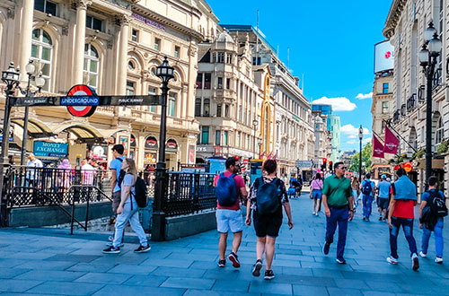 People walking through Piccadilly circus. Piccadilly Circus