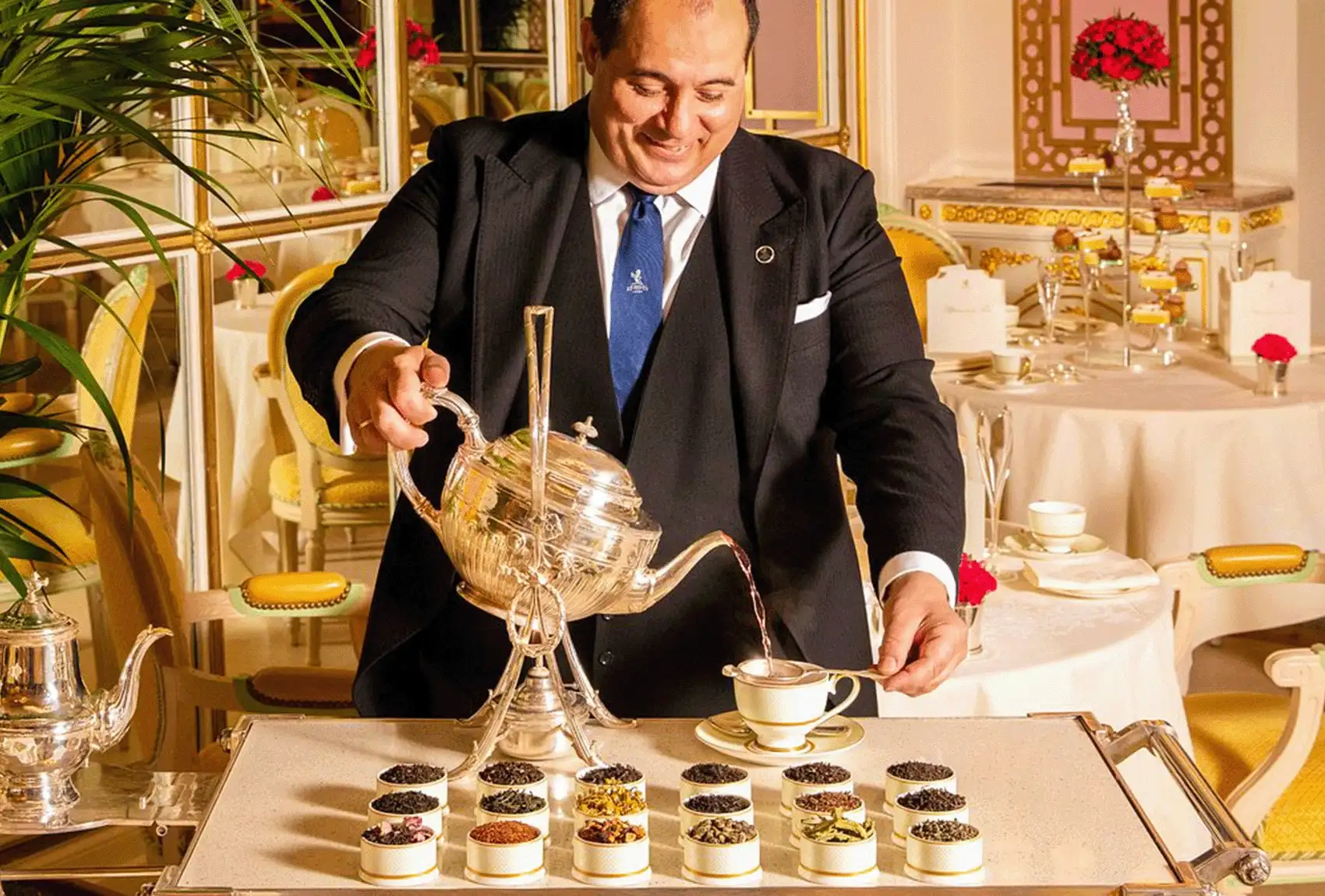 Waiter pouring tea at The Ritz Hotel London.