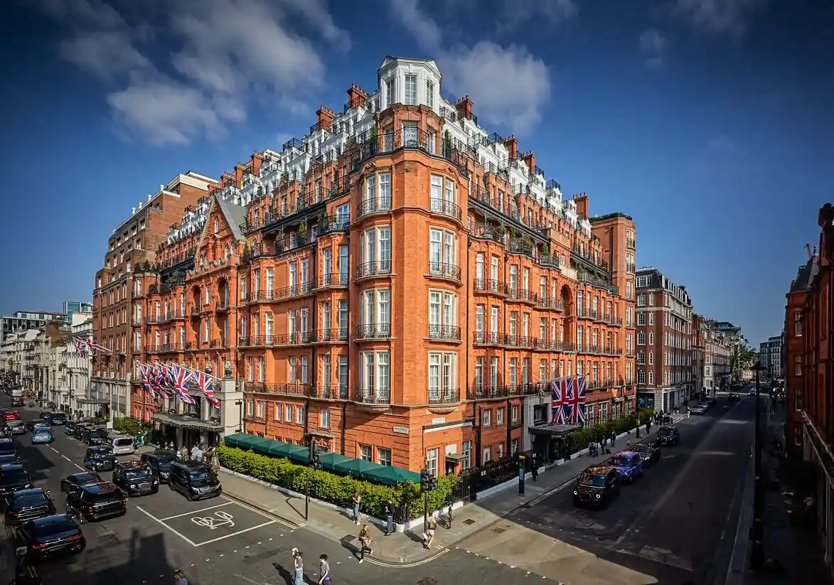 Claridges Mayfair London hotel with red brick exterior and the British flags.