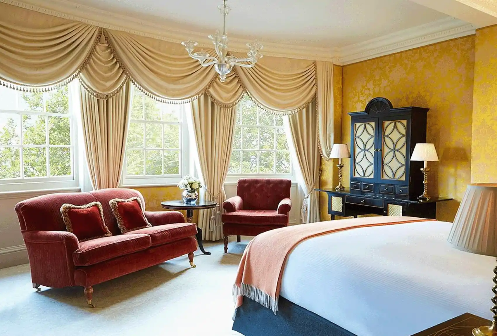 The Goring Hotel with Elegant Hotel Room With Bed, sofas and furniture.