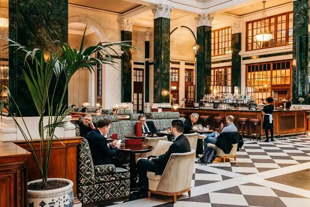 The Ned hotel London where guests enjoy a meal at the grand dining hall.
