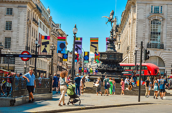People walking around Piccadilly Circus. Piccadilly Circus London.