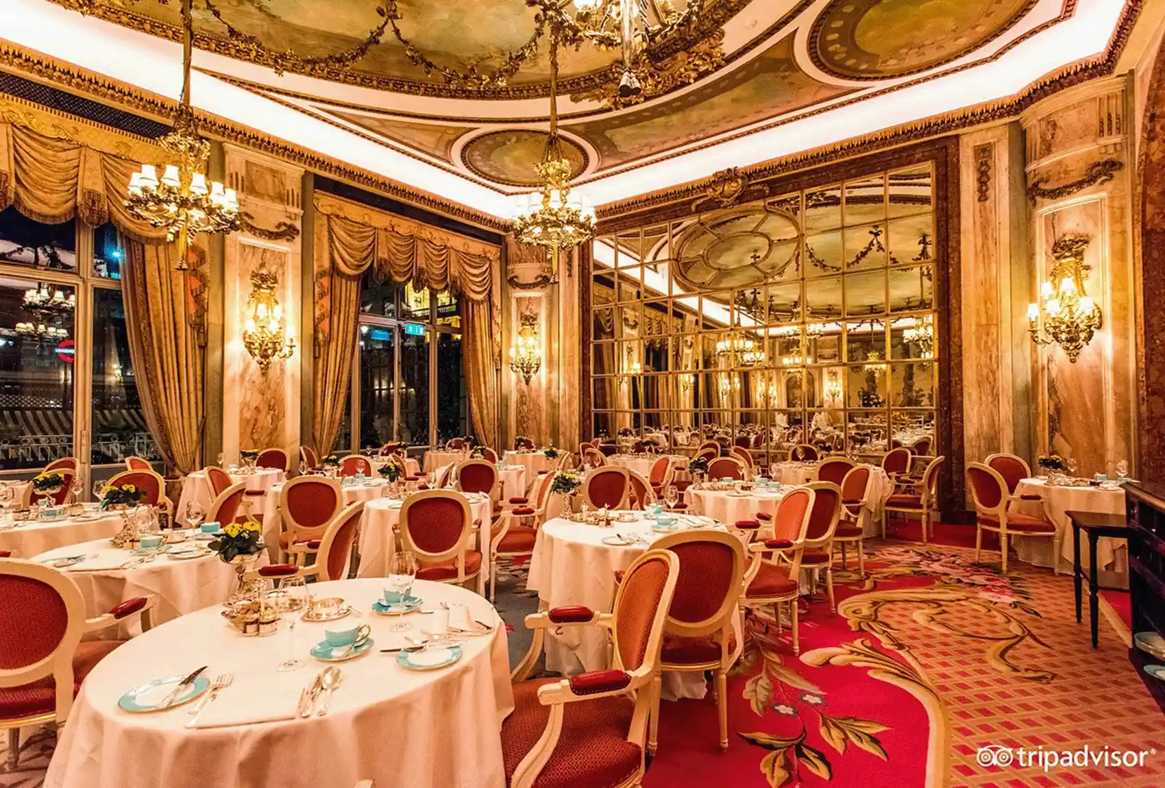 Elegant dining room with ornate decor and luxurious chandeliers at The Ritz Hotel London.