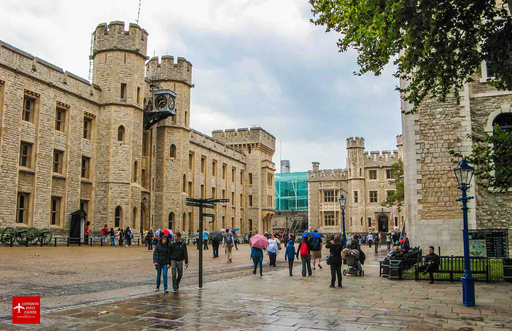 People walking at the Tower of London on a rainy day. A rainy day at the Tower of London.