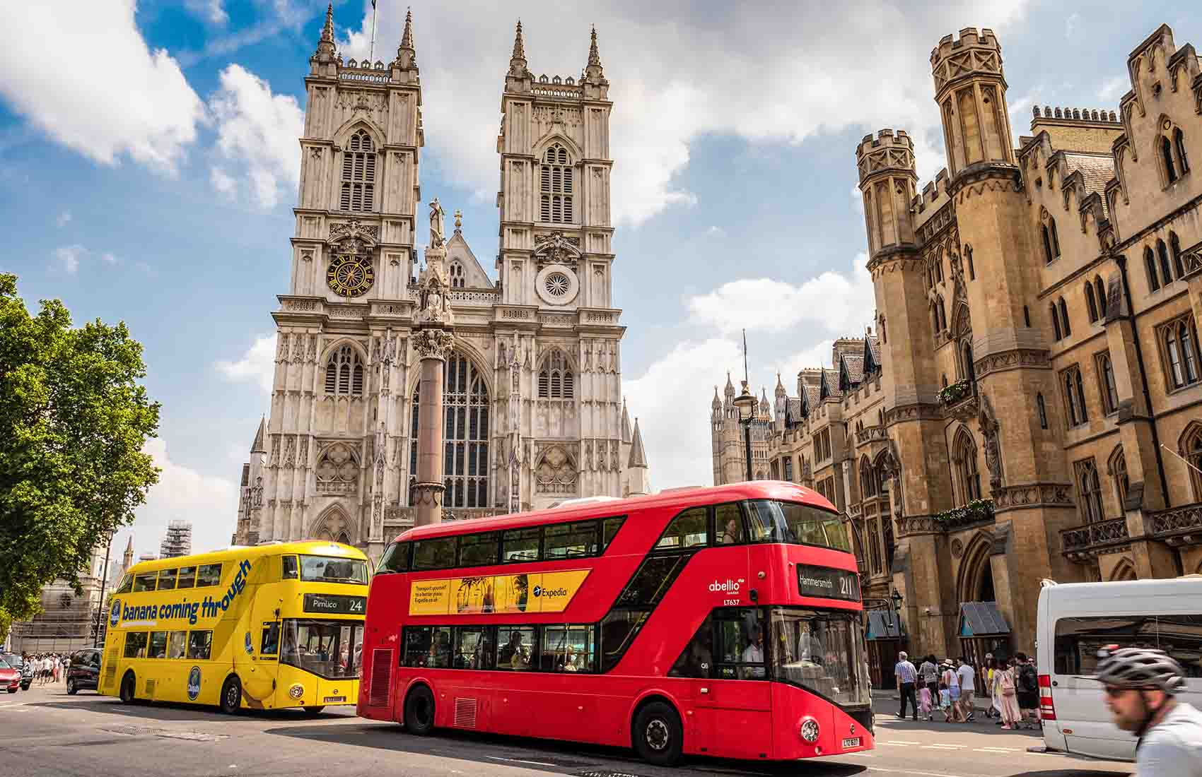 Two London buses parked outside of Westminster Abbey in London. The outside of Westminster Abbey in London.