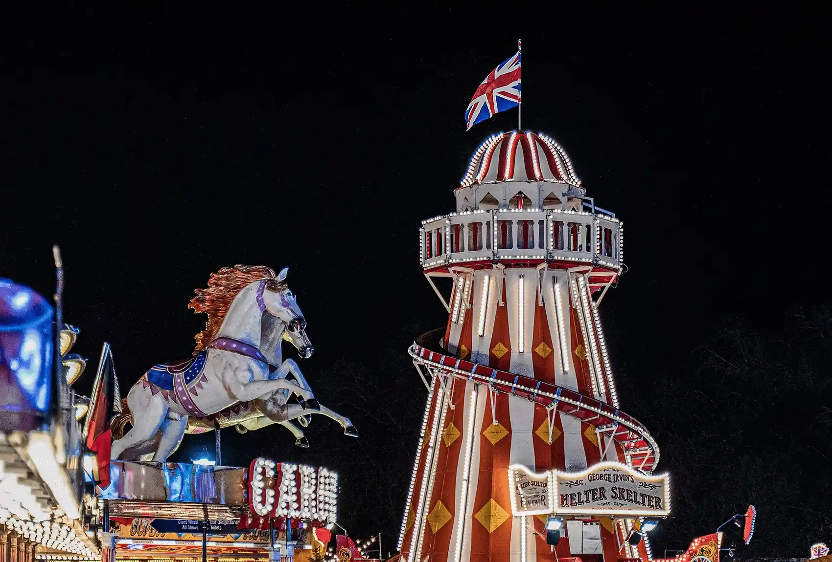 Brightly illuminated Helter Skelter tower ride at Winter Wonderland, Hyde Park, London. Helter Skelter tower ride at Winter Wonderland, Hyde Park London
